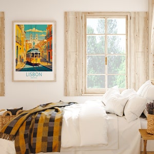 May include: A framed poster with a colorful illustration of a yellow tram traveling through a street in Lisbon, Portugal. The poster has the text "LISBON, PORTUGAL" at the bottom.
