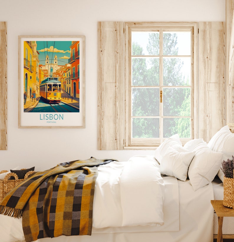 May include: A framed poster with a colorful illustration of a yellow tram traveling through a street in Lisbon, Portugal. The poster has the text "LISBON, PORTUGAL" at the bottom.