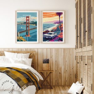 May include: Two framed travel posters, one with a view of the Golden Gate Bridge in San Francisco and the other with a view of a car driving along the Pacific Coast Highway in Del Mar, California.