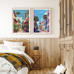 May include: Two framed illustrations of cityscapes. The left illustration shows a street in St. Augustine, Florida, with a tall building with a clock tower. The right illustration shows a street in Charleston, South Carolina, with a church steeple in the background.
