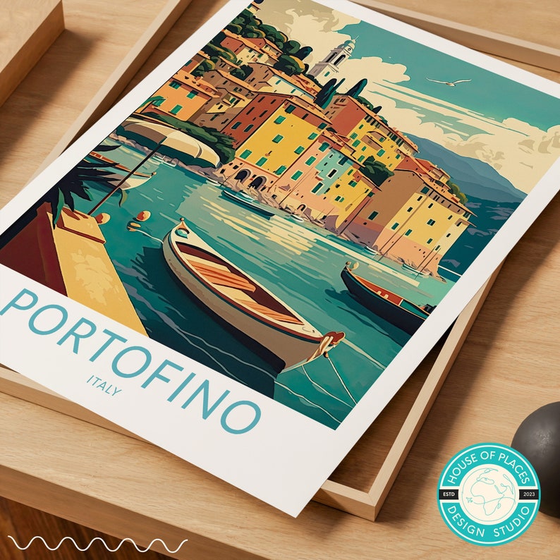 May include: A vintage travel poster featuring a colorful illustration of the Italian town of Portofino, with boats in the water and buildings on a hillside. The text "Portofino, Italy" is at the bottom of the poster.