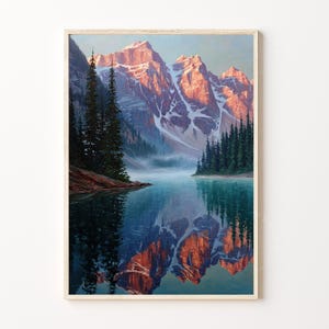May include: A framed landscape painting depicts a mountain range with snow-capped peaks reflecting in a calm lake. The mountains are illuminated by the sun, with a forest on the right and left sides of the lake.