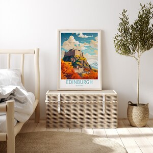 May include: A vintage travel poster featuring a colorful illustration of Edinburgh Castle in Scotland. The poster has a blue sky with white clouds and a green hill with orange and red trees.