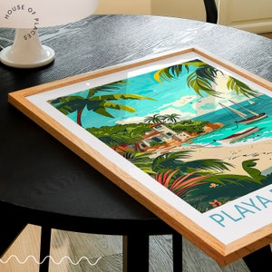 May include: A framed illustration of a tropical beach scene with a white building, palm trees, and sailboats. The text "PLAYA" is at the bottom of the image.