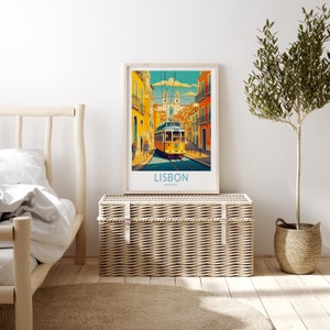 May include: A vintage-style travel poster featuring a yellow tram traveling up a hill in Lisbon, Portugal. The poster has a blue and teal color scheme with a white border.
