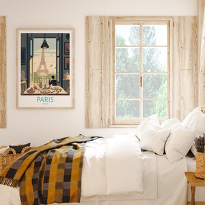 May include: A vintage travel poster with an illustration of the Eiffel Tower in Paris, France. The poster shows a couple sitting at a table with a view of the Eiffel Tower. The text on the poster reads "Paris, France".
