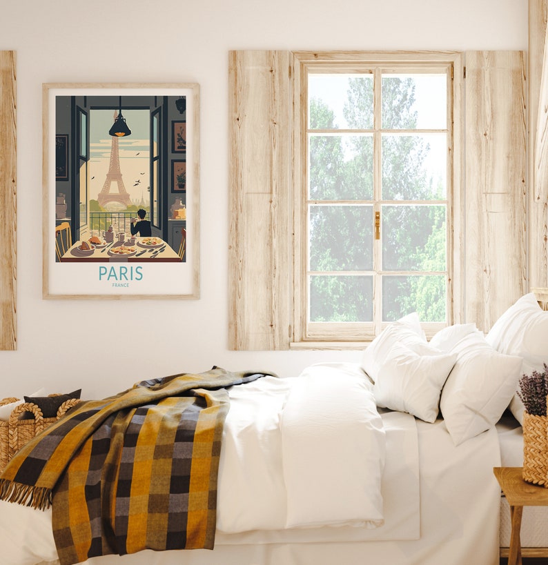 May include: A vintage travel poster with an illustration of the Eiffel Tower in Paris, France. The poster shows a couple sitting at a table with a view of the Eiffel Tower. The text on the poster reads "Paris, France".