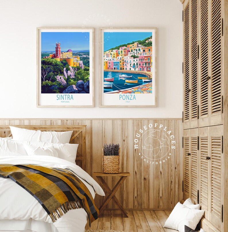 May include: Two framed travel art prints. One shows Sintra, Portugal, with a colourful palace on a hilltop. The other depicts Ponza, Italy, with vibrant buildings and boats. Both prints have text at the bottom.