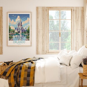 May include: A framed print of a colourful illustration of Cinderella's Castle at Walt Disney World in Orlando, Florida. The print is hanging on a wall above a white bed with a yellow and black plaid blanket.