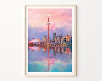 May include: A framed art print featuring a watercolor-style illustration of the Toronto skyline at sunset. The image displays the CN Tower and city buildings reflected in water, with the text TORONTO CANADA centered above the skyline.