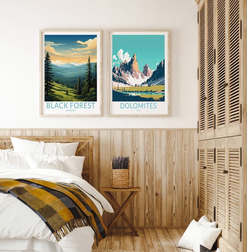 May include: Two framed landscape posters with mountain scenes. The poster on the left shows a forest scene with the text "BLACK FOREST, GERMANY". The poster on the right shows a mountain range with the text "DOLOMITES, ITALY".