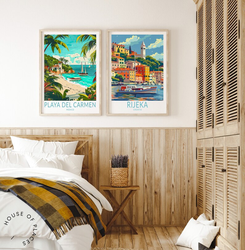 May include: Two framed travel posters, one depicting a beach scene with palm trees and the text "PLAYA DEL CARMEN, MEXICO" and the other depicting a colorful cityscape with the text "RIJEKA, CROATIA". The posters are hanging on a light wood wall above a white bed with a yellow and black blanket.