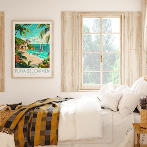 May include: A framed poster with a colorful illustration of a beach scene with palm trees, a boat, and the text "PLAYA DEL CARMEN, MEXICO". The poster is hanging on a white wall above a bed with a white duvet and a yellow and black plaid throw blanket.
