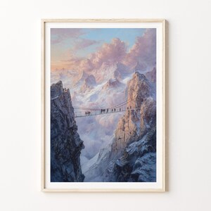 May include: Framed art print depicting a mountain scene. A rope bridge spans between two rocky peaks, with people crossing. The sky is filled with pastel clouds, and the mountains are snow-covered. The artwork is in a wooden frame.
