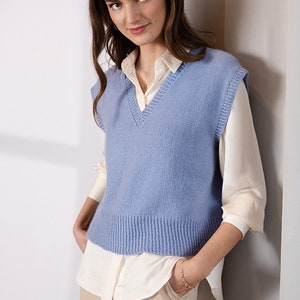 May include: A light blue knitted vest with a V-neck and a ribbed hem.