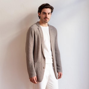 May include: A brown linen blazer with a textured pattern. The blazer has a single button closure and a patch pocket on the left side.