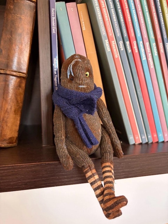 A one-of-a-kind handmade art doll sitting in the creepy-cute sweet spot — the kind of shelf companion that makes every visitor stop and ask 'what IS that?'