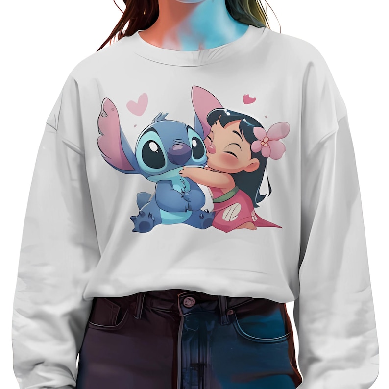 May include: White sweatshirt with a blue and pink cartoon image of Stitch and Lilo from the Disney movie Lilo & Stitch. Stitch is hugging Lilo and they both have hearts around them.