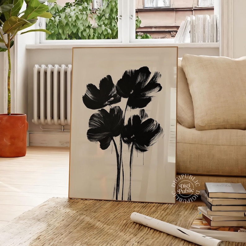 Framed digital artwork of abstract black flowers created with bold brush strokes on a light background, minimalist botanical printable wall art.
