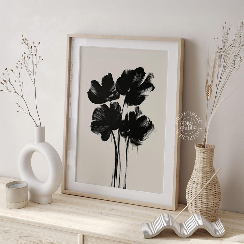 Framed digital artwork of abstract black flowers created with bold brush strokes on a light background, minimalist botanical printable wall art.