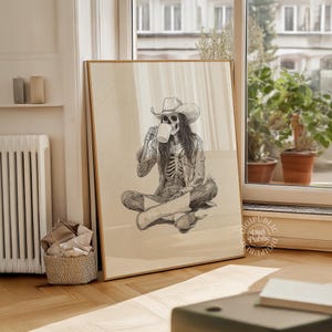 Detailed black-and-white illustration of a skeleton cowgirl in a hat and boots, sitting cross-legged while drinking coffee, rustic gothic western style.