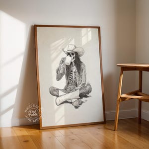 Detailed black-and-white illustration of a skeleton cowgirl in a hat and boots, sitting cross-legged while drinking coffee, rustic gothic western style.