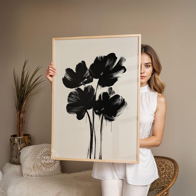 Framed digital artwork of abstract black flowers created with bold brush strokes on a light background, minimalist botanical printable wall art.
