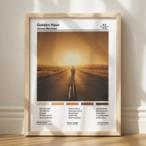 May include: A framed poster titled Golden Hour by James Morrison featuring a central photograph of a person standing on a road at sunset. Below the image are five color swatches, a tracklist, release date September 22, 2023, and label details.