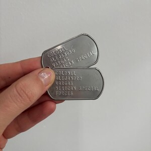 May include: Two silver dog tags with the text "COLONEL ALEJANDRO VARGAS MEXICAN SPECIAL FORCES" on them.