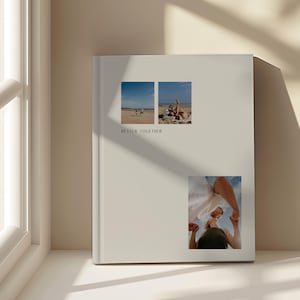 May include: A cream-coloured photo album featuring three small rectangular images. The top two show people on a beach. The bottom image shows a person looking upwards. The words "BETTER TOGETHER" are printed on the album.
