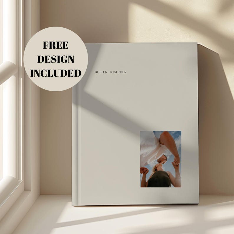 May include: A light beige book with the words "Better Together" printed on the cover. A small photo is affixed to the lower right corner. A circular sticker on the upper left reads "FREE DESIGN INCLUDED."