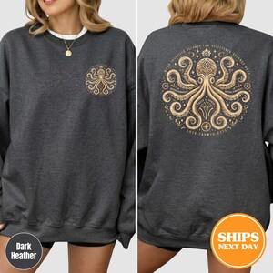 Puede incluir: Sudadera gris oscuro con un dise&ntilde;o de pulpo dorado en la parte delantera y trasera. El dise&ntilde;o trasero incluye el texto "Cuando la injusticia se convierte en ley, la resistencia se convierte en deber". La sudadera tiene cuello redondo y mangas largas.