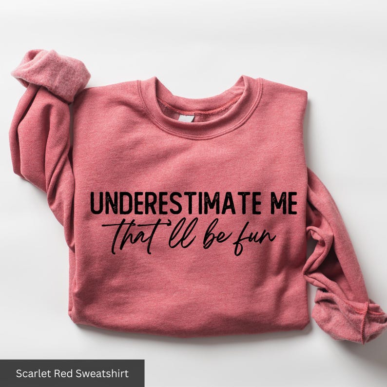 a pink shirt that says, underestimate me that i'll be