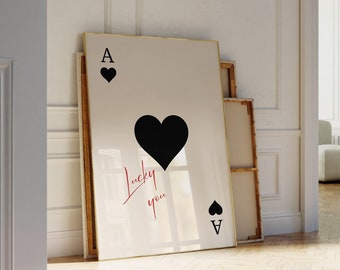 May include: A framed print of a black ace of spades playing card with a black heart and the text "Lucky you" in red cursive.