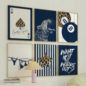 May include: A set of framed wall art with diverse designs. The art includes a playing card with a leopard print spade, a yawning leopard, a pool ball, a star, and text that reads "What if it all works out?"