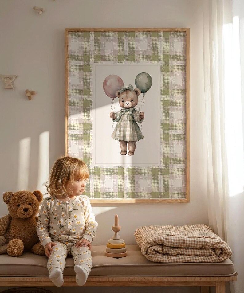 May include: A framed print of a teddy bear holding balloons, set against a green and white plaid background. A child in a daisy-print onesie sits on a bench with a teddy bear and a wooden stacking toy. A plaid blanket is also on the bench.