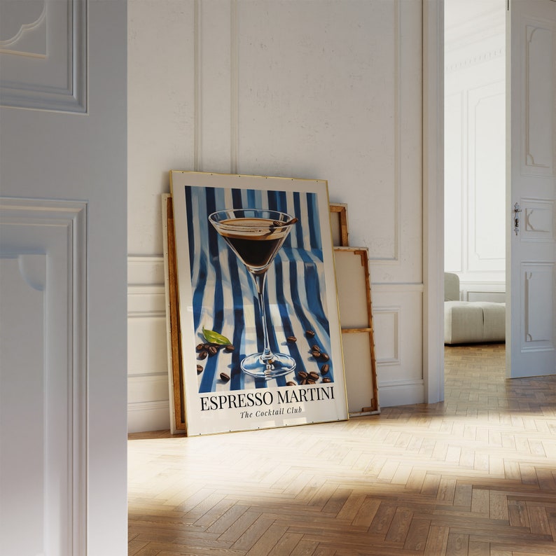 May include: A poster with a blue and white striped background featuring a martini glass filled with a dark liquid and coffee beans. The text on the poster reads "Espresso Martini The Cocktail Club".