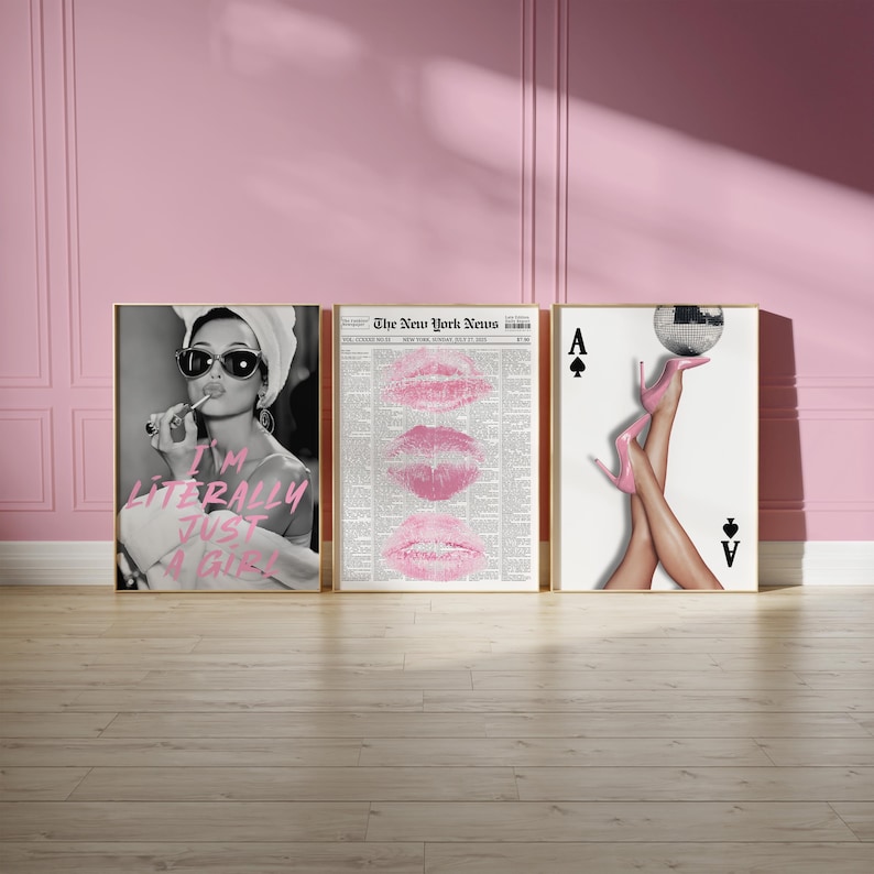 May include: Three framed art prints. The first shows a black and white image of a woman applying lipstick with the text "I'M LITERALLY JUST A GIRL". The second print features pink lips on a newspaper background. The third print displays legs in pink heels and a disco ball.