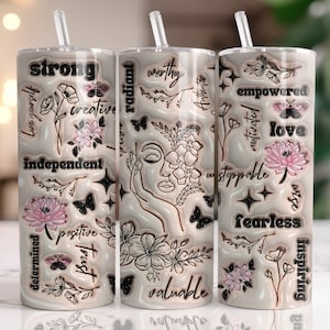 May include: Three stainless steel tumblers with black and pink floral designs and motivational words like "strong", "radiant", "worthy", "empowered", "love", "fearless", and "inspiring".