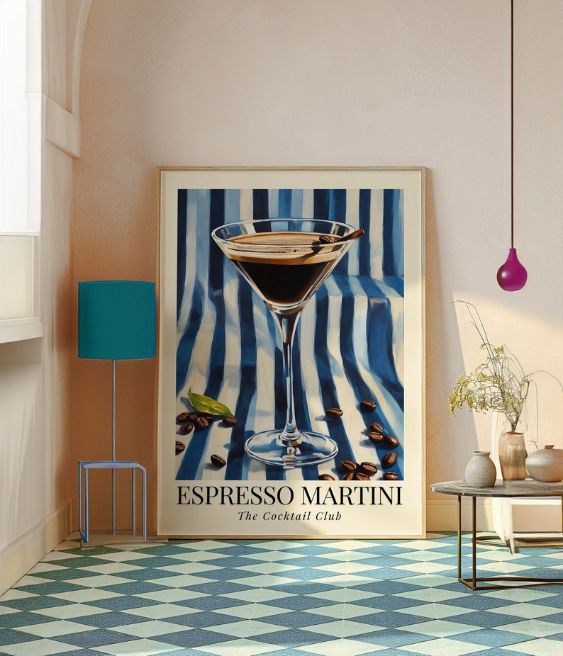 May include: A framed poster with a blue and white striped background featuring a martini glass filled with espresso. The text "Espresso Martini The Cocktail Club" is printed below the glass.