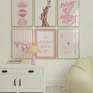 May include: A gallery wall featuring six framed prints in pink and white tones. The art includes pink lips, legs in pink heels with a martini, the text "WHAT IF IT ALL WORKS OUT?", lingerie on a clothesline, the text "i'm literally just a girl", and an ace of hearts card with the text "How lucky are we?" above a lamp and white cabinet.