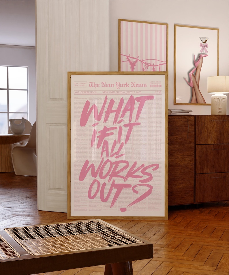 May include: A framed vertical poster featuring a newspaper-style background with the text "WHAT IF IT ALL WORKS OUT?" written in large, bold, pink brush-stroke lettering. The poster is displayed in a light wood frame, showcasing a newspaper layout.