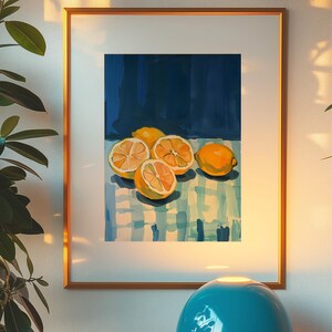 May include: A framed painting of lemons on a blue and white checkered tablecloth. The lemons are yellow and have been cut in half, revealing their juicy insides. The background is a dark blue.