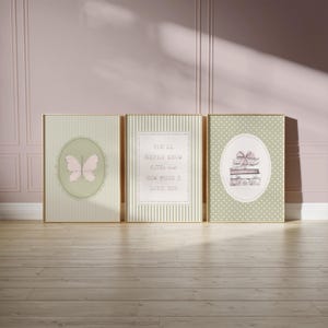 May include: Three framed art prints with gold frames. The prints feature a butterfly, text that reads "You'll never know little me how much I love you", and a stack of books with a bow. The backgrounds are striped and dotted.