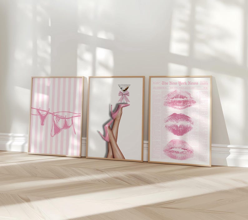 May include: Three framed art prints. The first features pink striped background with pink lingerie hanging on a clothesline. The second shows legs in pink high heels holding a martini glass. The third print displays three pink lip imprints.