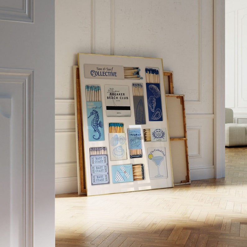May include: A framed collection of matchboxes with various designs, including a seahorse, a seashell, a cocktail glass, and the text "Sun & Surf Collective" and "Breaker Beach Club".