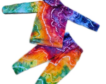 May include: A tie-dye hoodie and sweatpants set in a rainbow colour scheme with a white lightning bolt pattern. The hoodie has a hood and a kangaroo pocket. The sweatpants have a drawstring waistband.