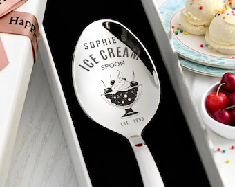 May include: A personalized ice cream spoon with the name "Sophie" and the words "Ice Cream Spoon" engraved on the spoon's surface. The spoon features a sundae graphic and the year "EST 1999". The spoon is presented in a gift box.