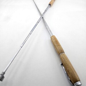 May include: Two telescopic extendable rods, one with a wooden handle and the other with a silver handle.