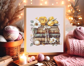 May include: A framed cross-stitch artwork depicts a stack of books adorned with yellow roses, white daisies, and greenery. The scene includes a candle, yarn balls, and a pink knitted scarf, creating a cozy, artistic theme. The artwork is in a wooden frame.